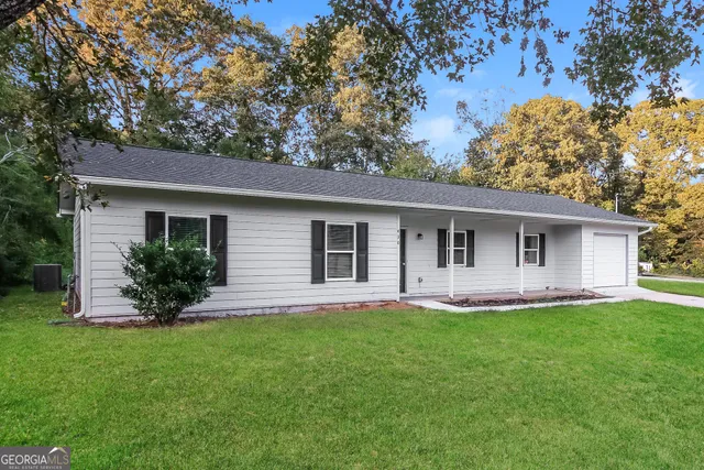 a front view of house with yard and green space