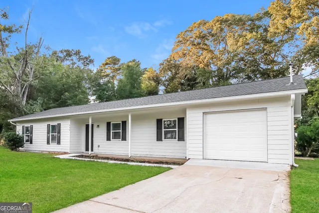 a front view of a house with a garden
