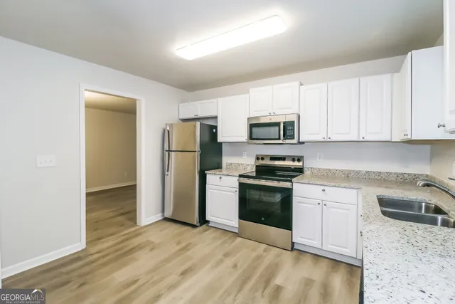 a kitchen with a refrigerator sink and microwave