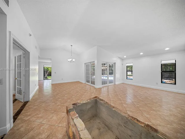 a view of a hallway with wooden floor and entryway