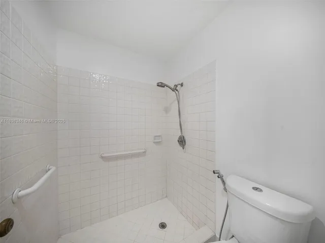 a view of empty room with window and ceiling fan