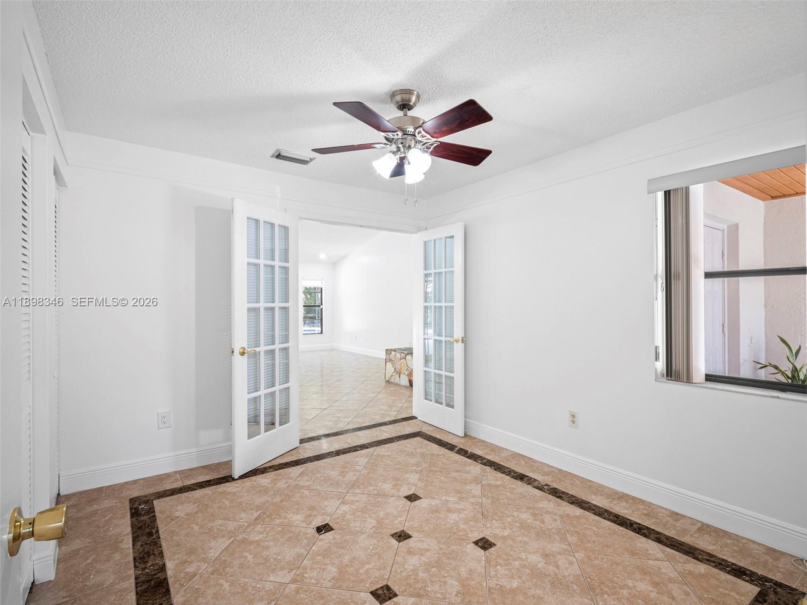 15531 Southwest 54th Terrace Miami, FL 33185 - Photo 17 of 61 a view of empty room with window and ceiling fan