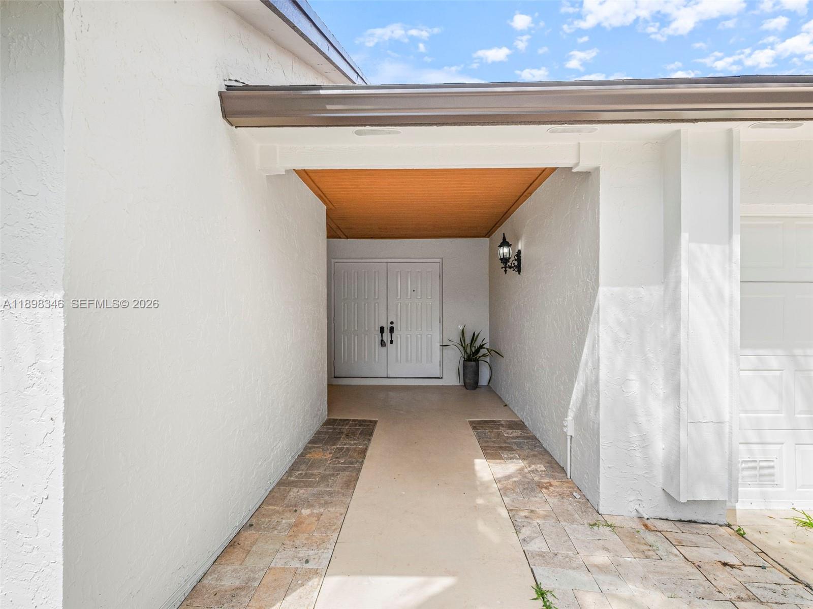15531 Southwest 54th Terrace Miami, FL 33185 - Photo 2 of 61 a view of a hallway with wooden floor and a window