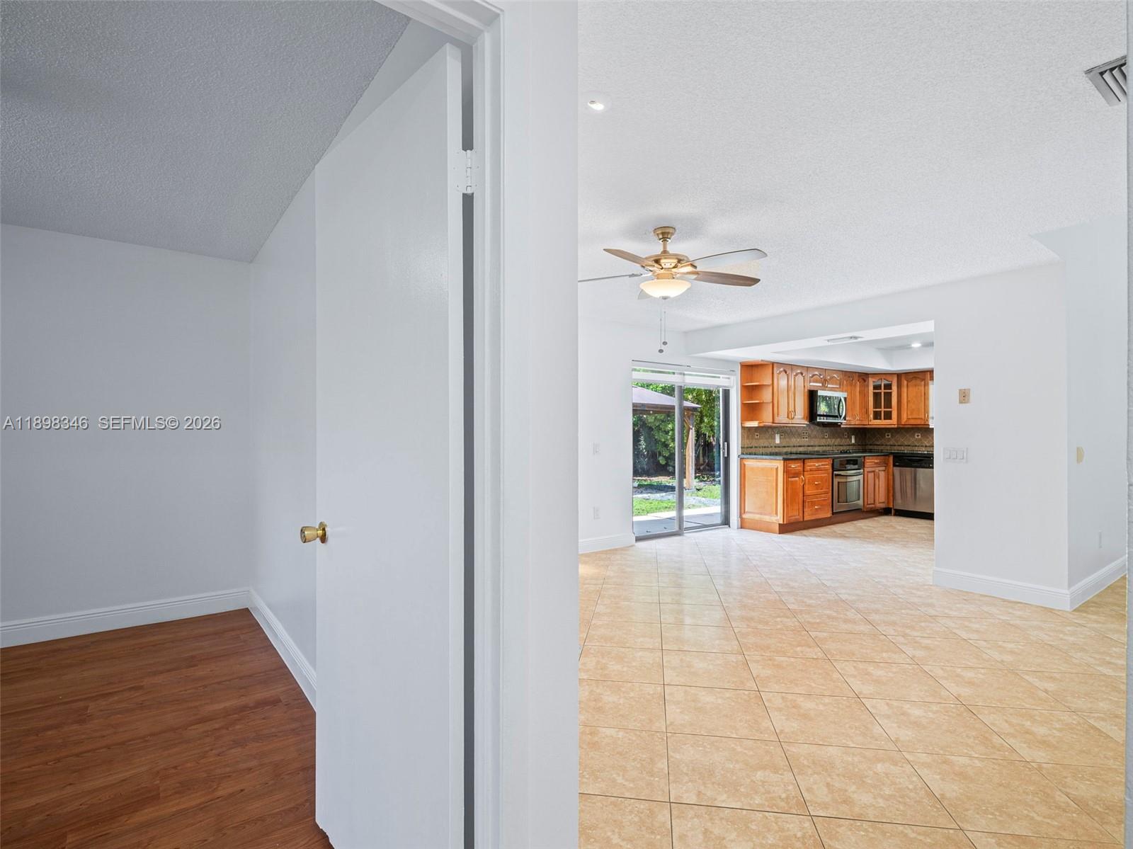 15531 Southwest 54th Terrace Miami, FL 33185 - Photo 21 of 61 a view of an empty room with wooden floor and a window