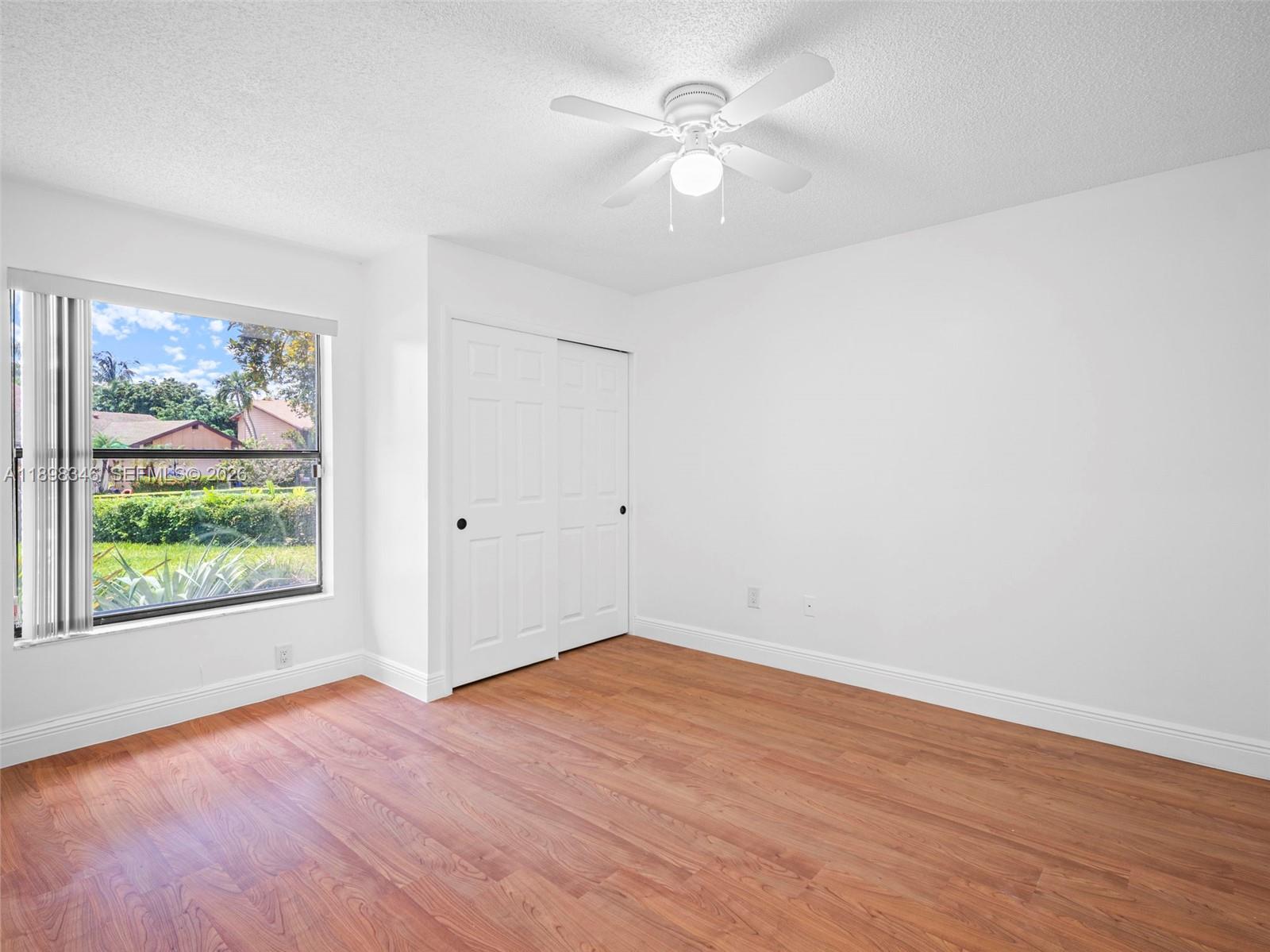 15531 Southwest 54th Terrace Miami, FL 33185 - Photo 22 of 61 a view of empty room with wooden floor and fan