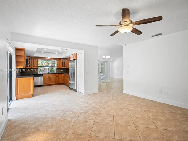 a kitchen with stainless steel appliances granite countertop a refrigerator and a sink