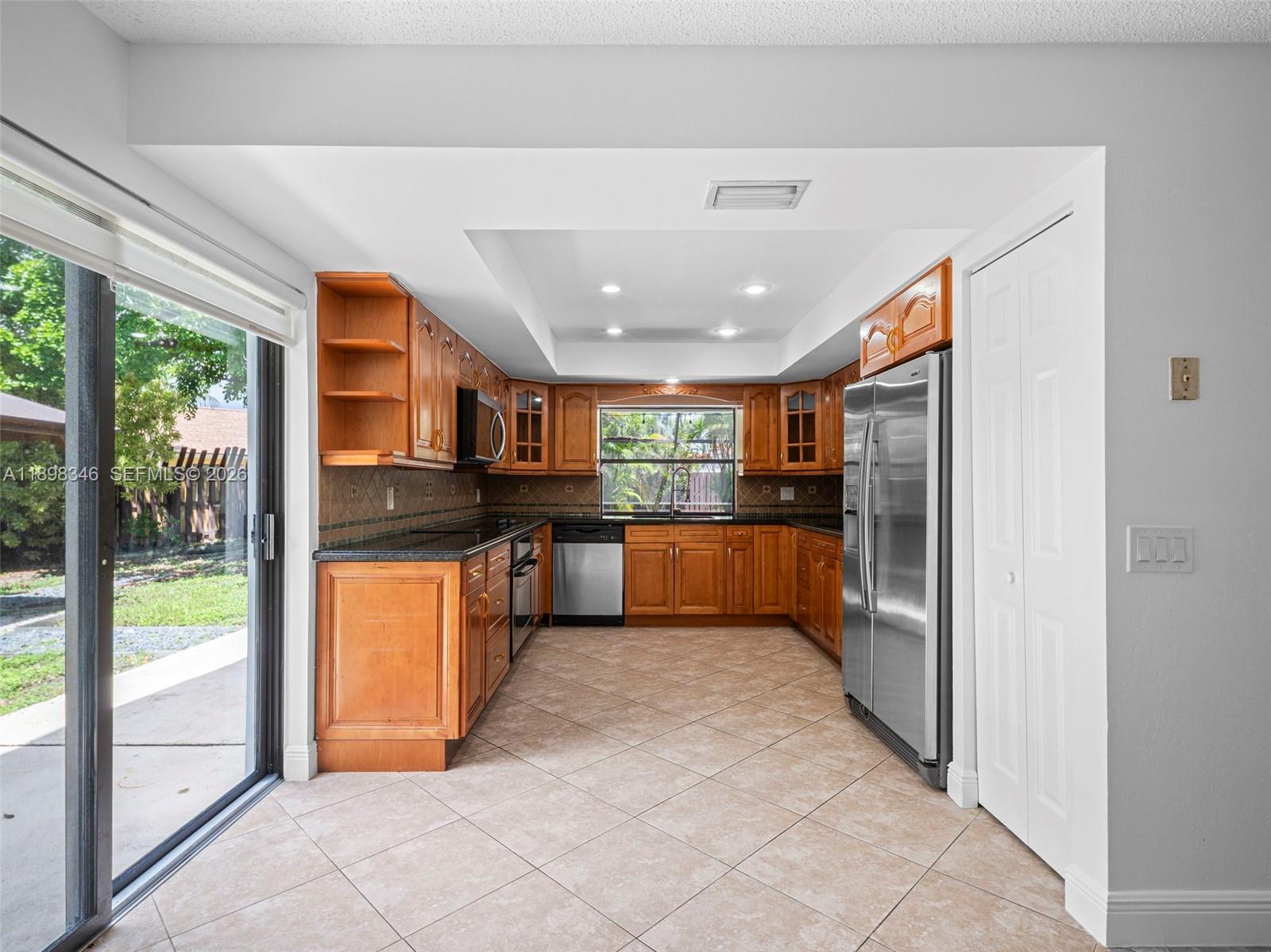 15531 Southwest 54th Terrace Miami, FL 33185 - Photo 27 of 61 a view of kitchen with stainless steel appliances granite countertop a refrigerator and a sink