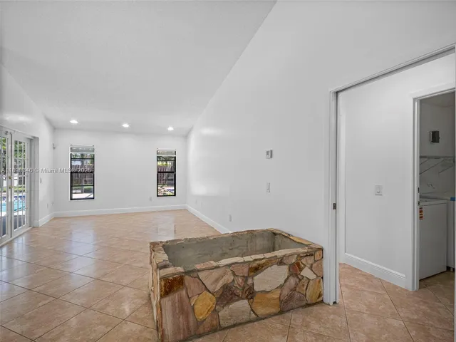 a living room with a bed and a chandelier
