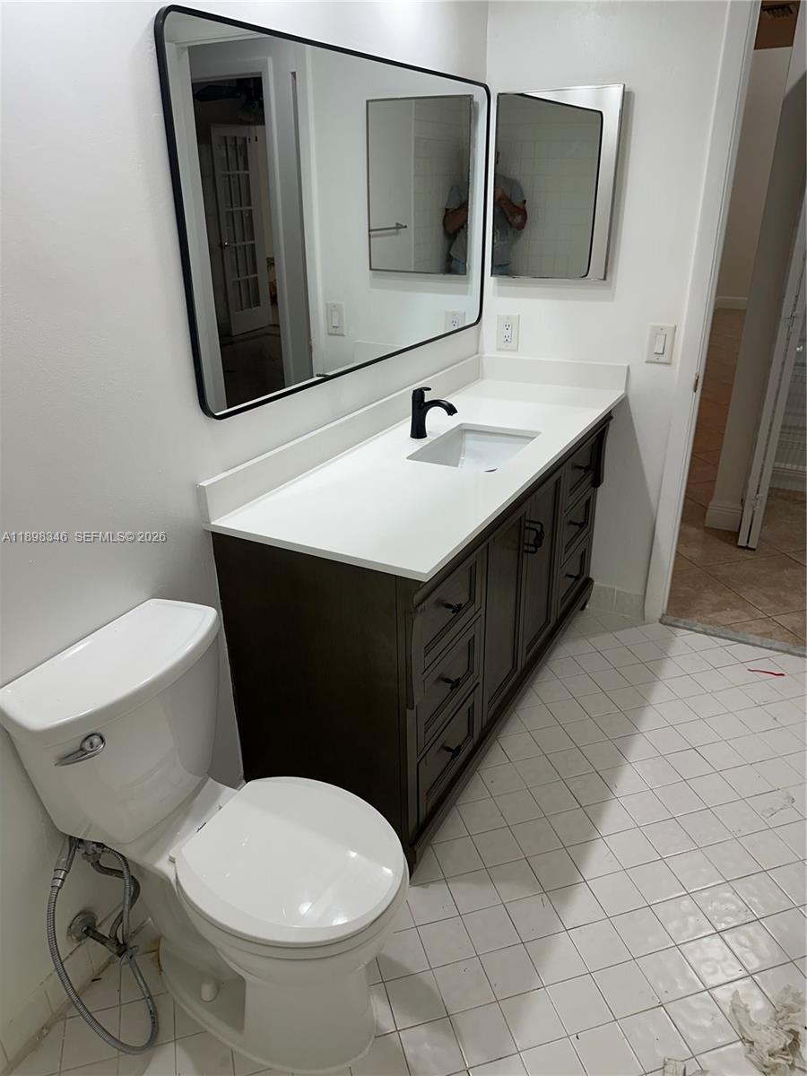 15531 Southwest 54th Terrace Miami, FL 33185 - Photo 31 of 61 a bathroom with a sink mirror and toilet