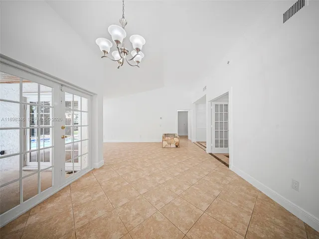 a view of a backyard with a garden and wooden fence
