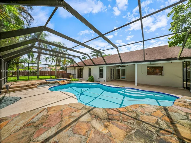 a view of a backyard with wooden fence