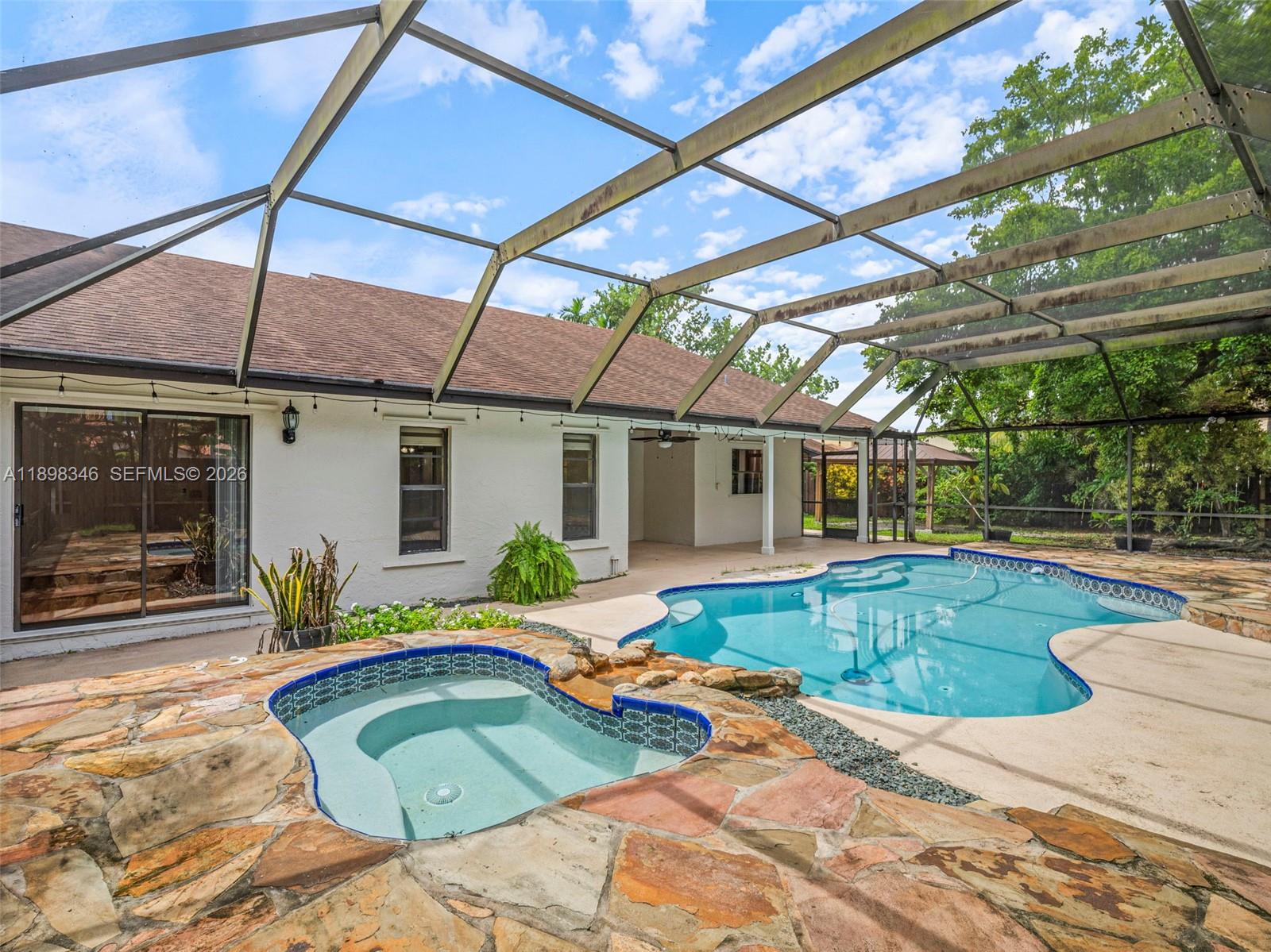 15531 Southwest 54th Terrace Miami, FL 33185 - Photo 43 of 61 a view of a backyard with swimming pool