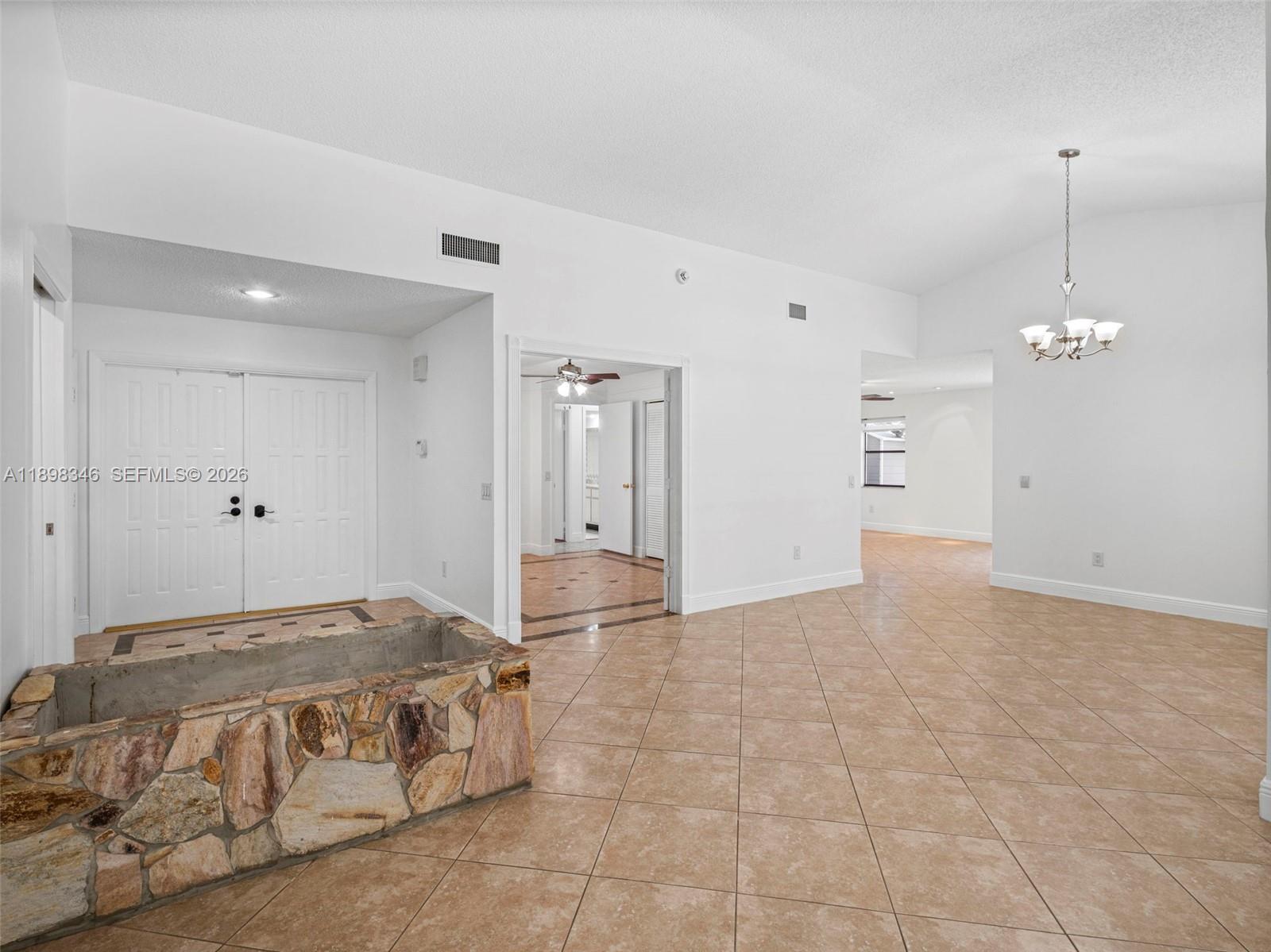 15531 Southwest 54th Terrace Miami, FL 33185 - Photo 5 of 61 a living room with a bed and a chandelier