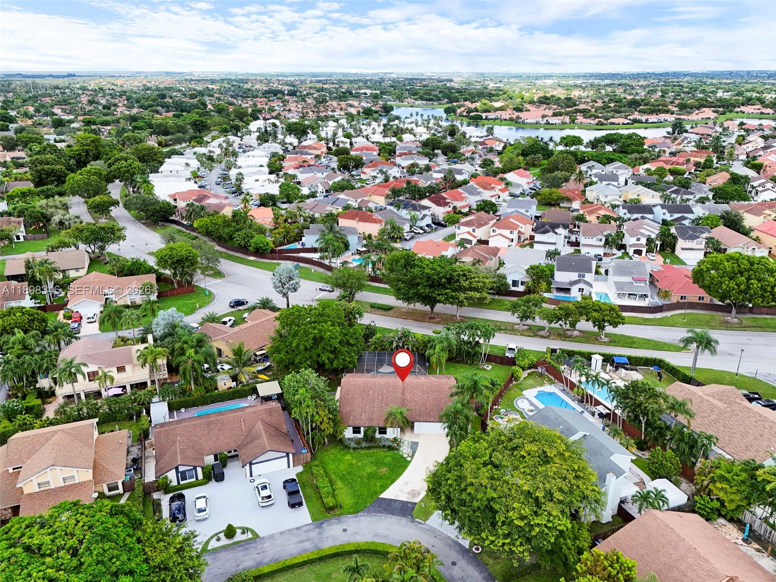 15531 Southwest 54th Terrace Miami, FL 33185 - Photo 59 of 61 an aerial view of a city with lots of residential buildings and mountain view in back