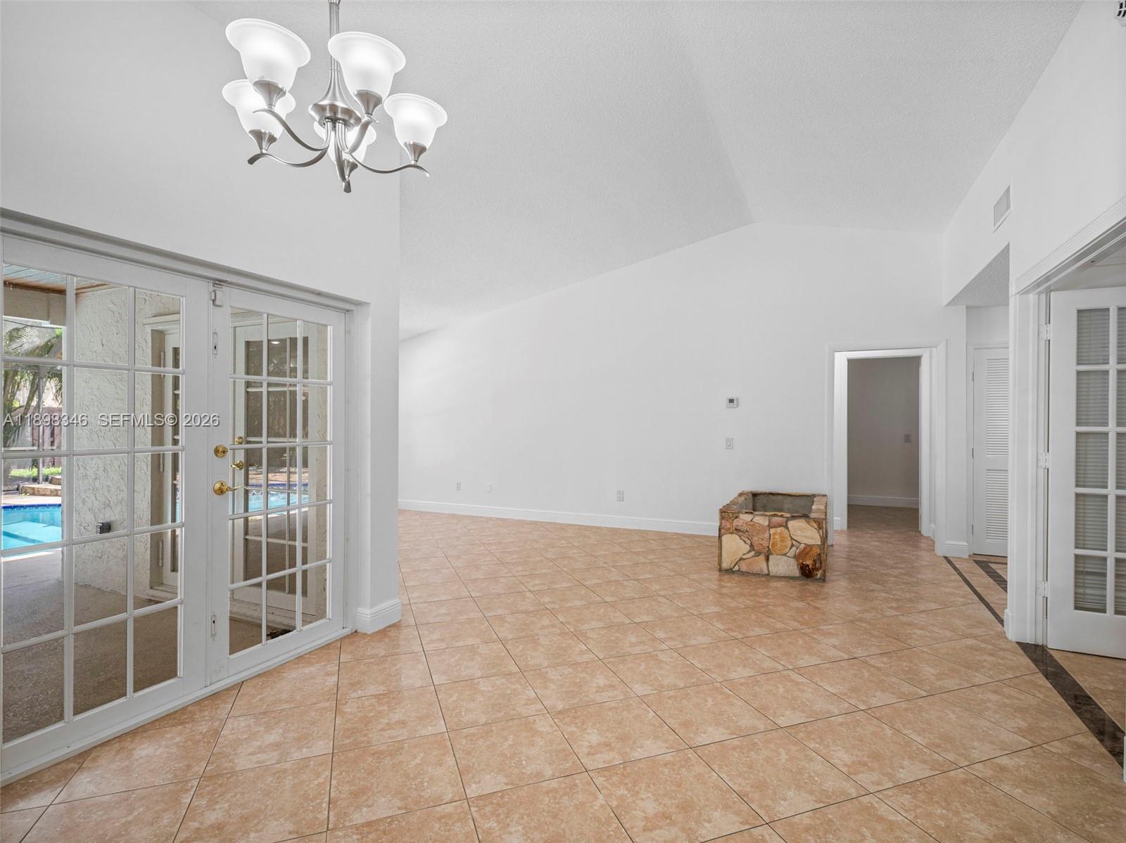 15531 Southwest 54th Terrace Miami, FL 33185 - Photo 7 of 61 a view of a livingroom with a lounge chair and chandelier