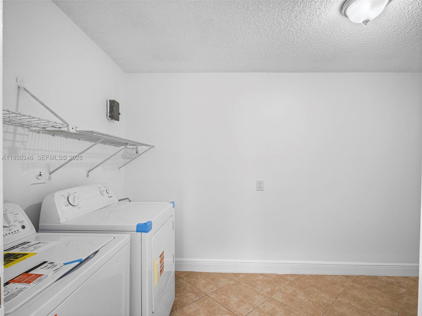 15531 Southwest 54th Terrace Miami, FL 33185 - Photo 9 of 61 a utility room with dryer and washer