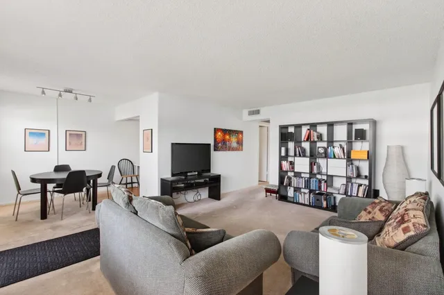 a view of a brick house with a yard and potted plants
