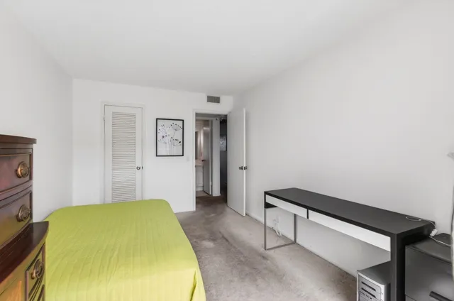 a front view of a building with a garden