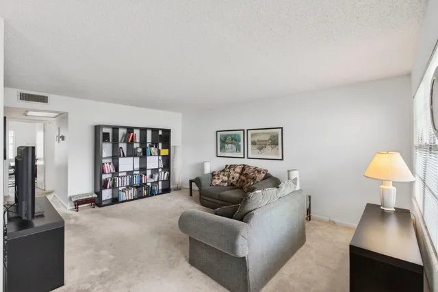 a view of a dining room with furniture and a window