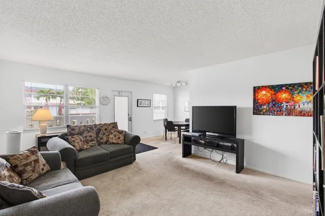 a view of a room with furniture and wooden floor