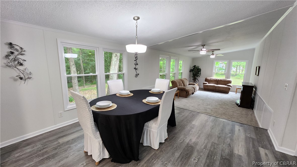 8065 Filly Run Road Gloucester, VA 23061 - Photo 5 of 33 Dining space featuring ceiling fan, a textured ceiling, and dark wood-type flooring