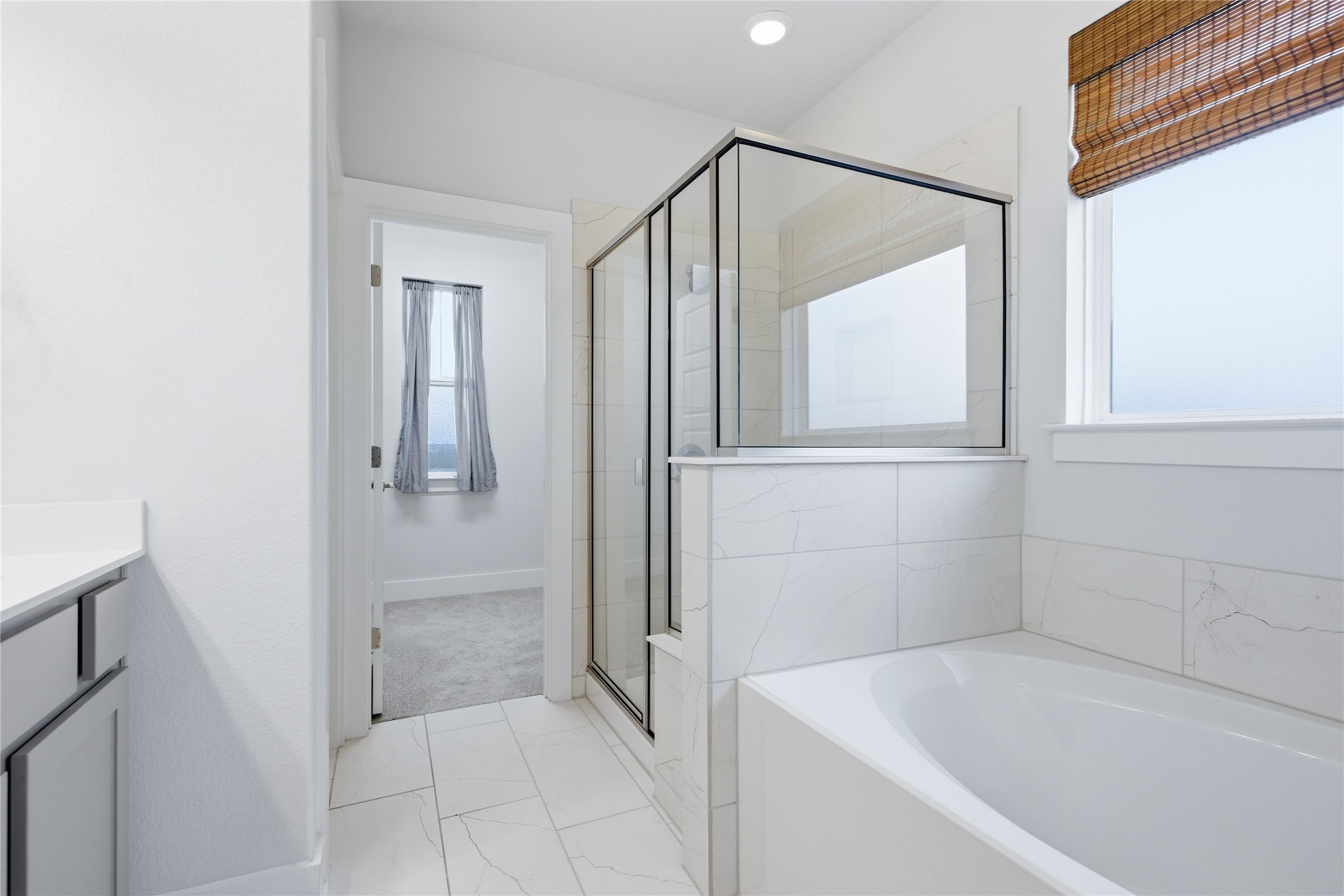 1300 Harwell Loop Kyle, TX 78640 - Photo 18 of 21 a bathroom with a bathtub and a shower
