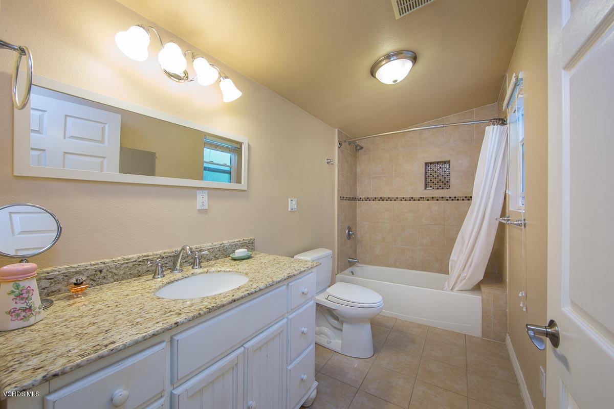 7748 Lilac Lane Simi Valley, CA 93063 - Photo 14 of 18 a bathroom with a granite countertop sink toilet and shower