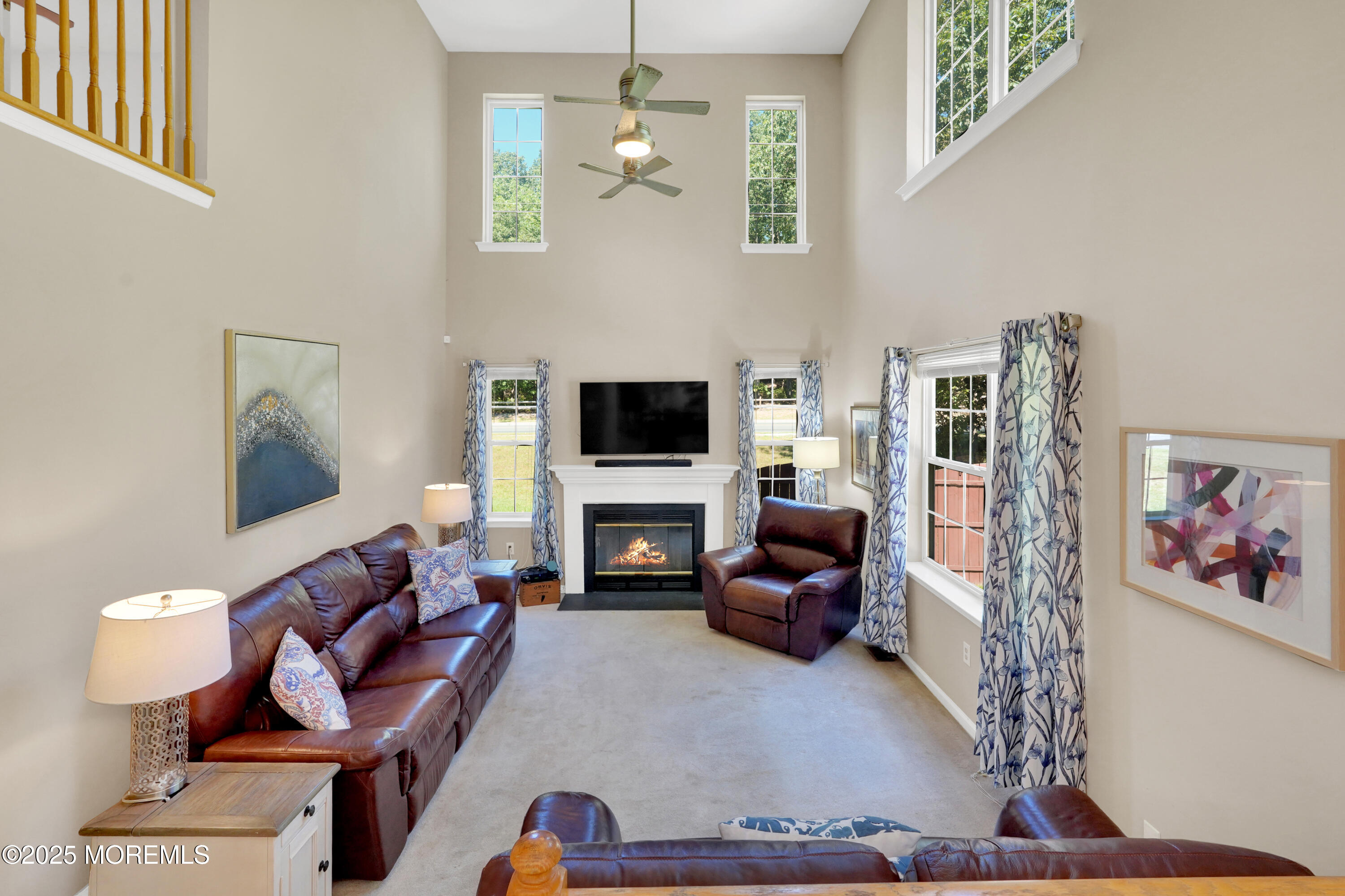 3 Diamond Lane Howell, NJ 07731 - Photo 12 of 43 a living room with furniture a flat screen tv and a fireplace