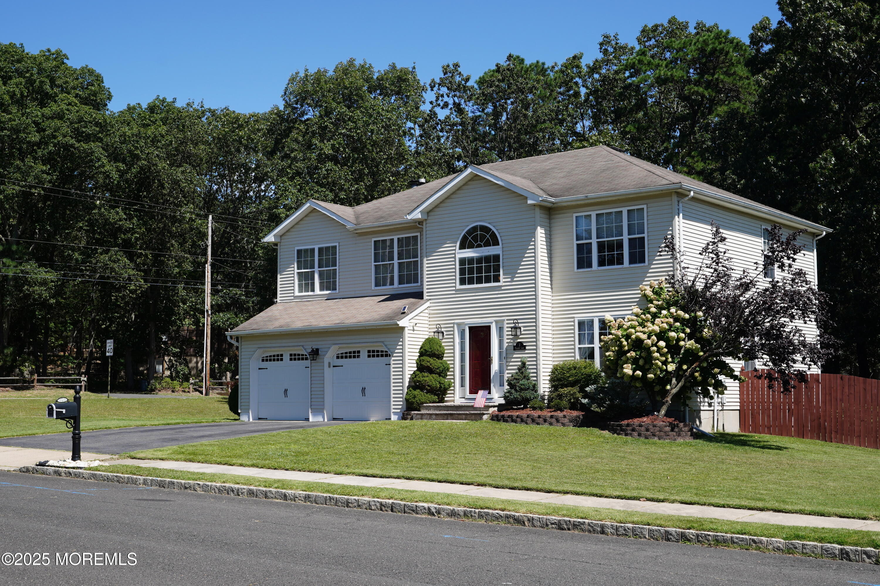 3 Diamond Lane Howell, NJ 07731 - Photo 3 of 43 a front view of a house with a garden and trees