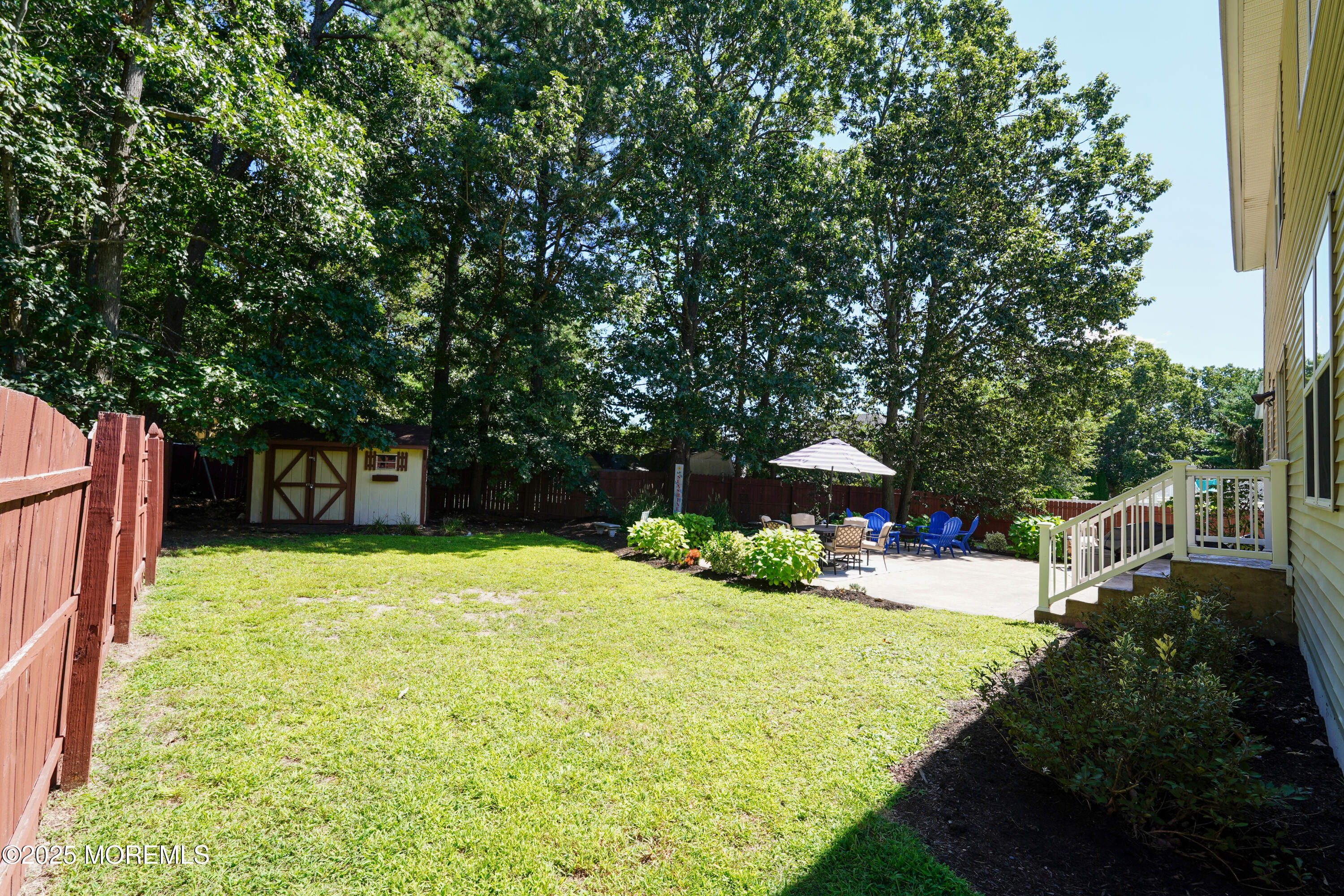 3 Diamond Lane Howell, NJ 07731 - Photo 32 of 43 a white house with a yard plants and large trees