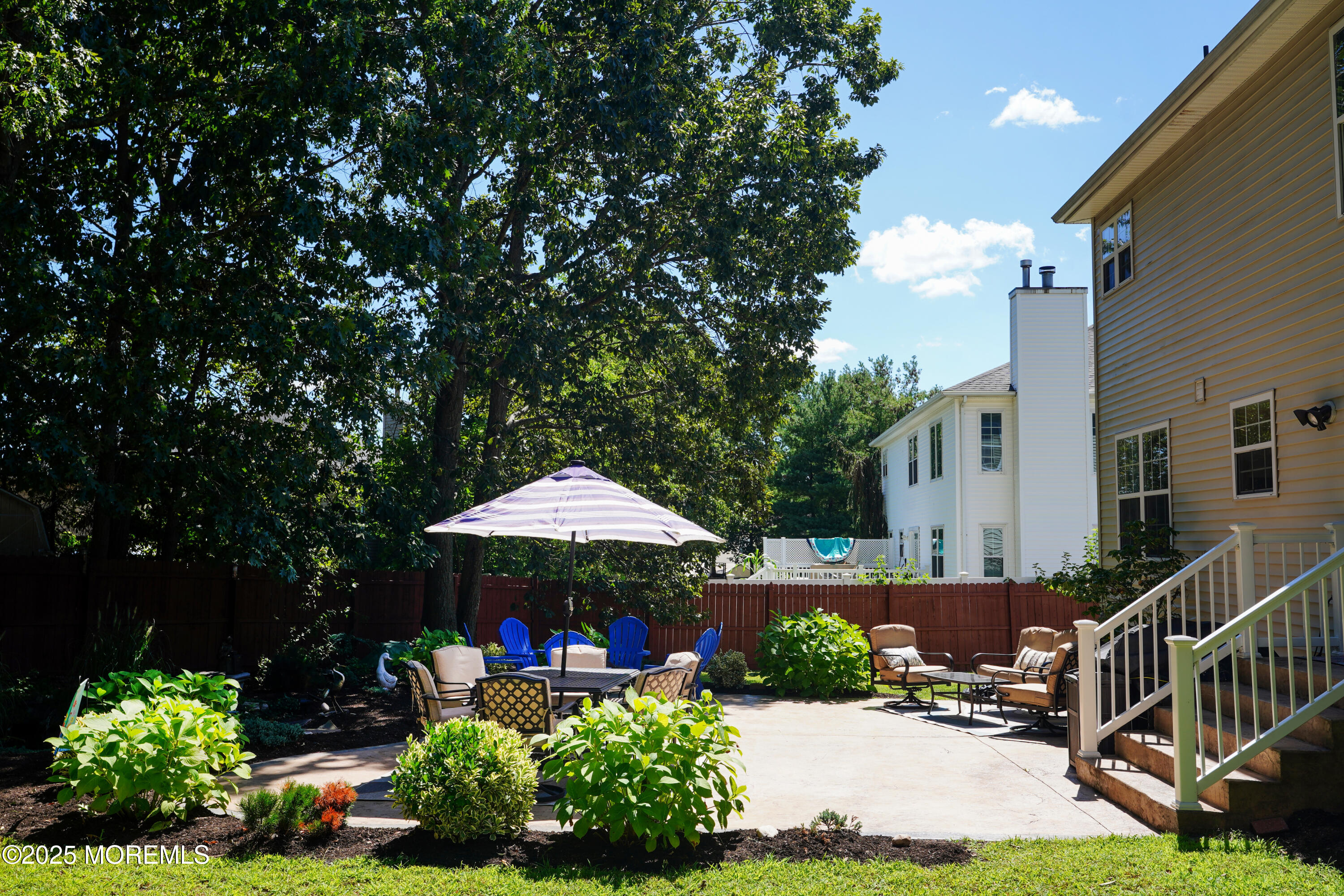 3 Diamond Lane Howell, NJ 07731 - Photo 35 of 43 a view of patio with table and chairs under an umbrella