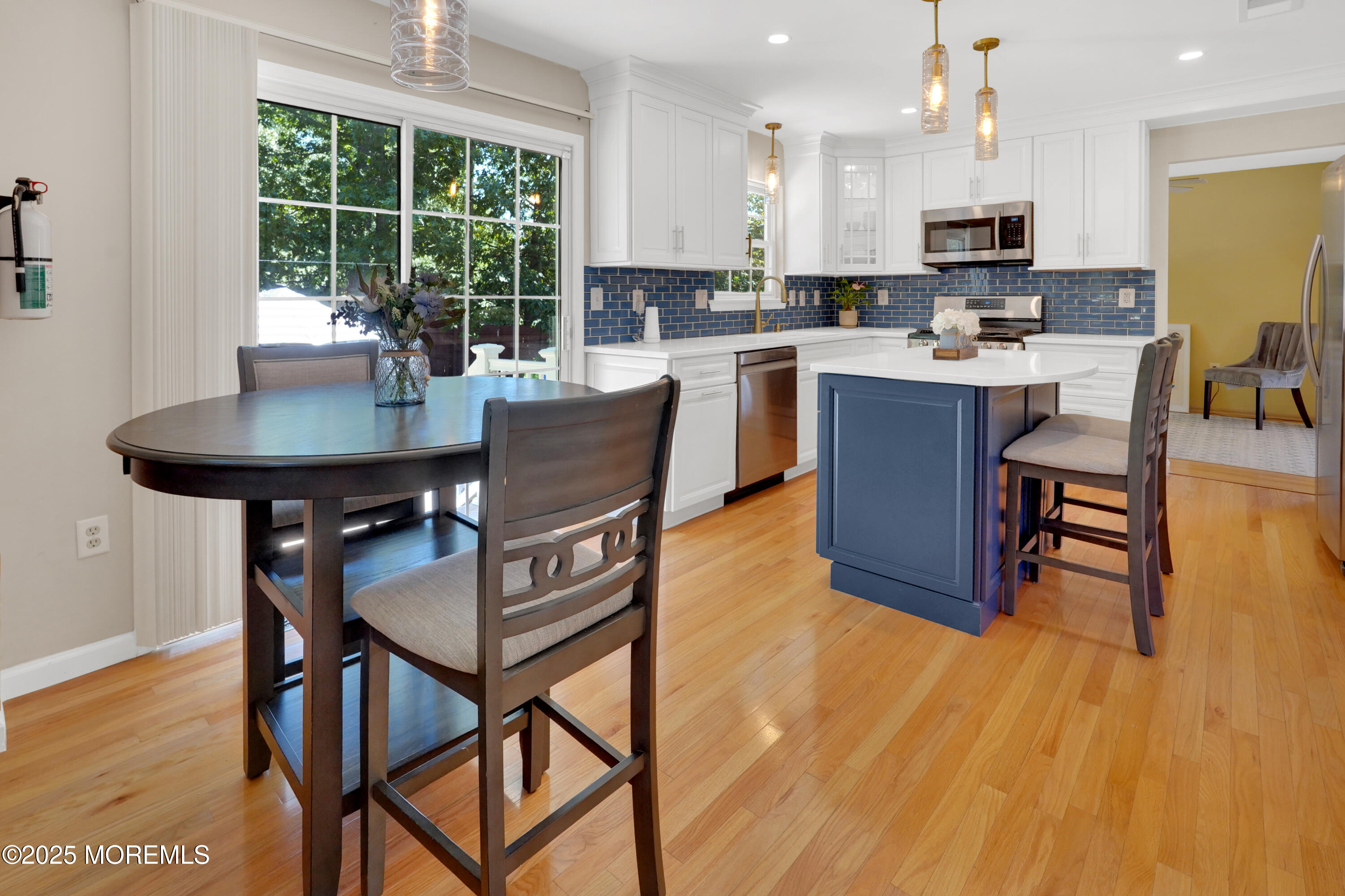 3 Diamond Lane Howell, NJ 07731 - Photo 10 of 43 a kitchen with stainless steel appliances kitchen island granite countertop a table chairs sink and cabinets