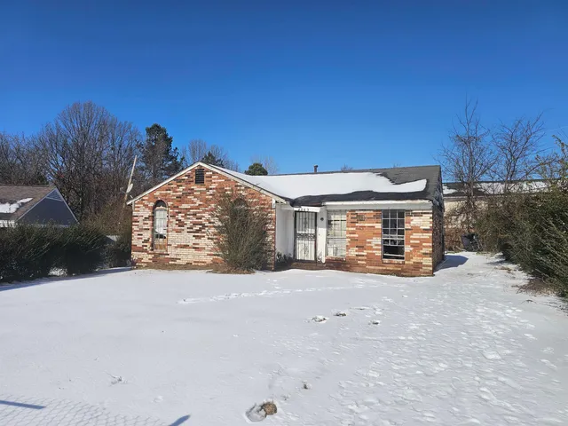 a view of a house with a snow in the yard