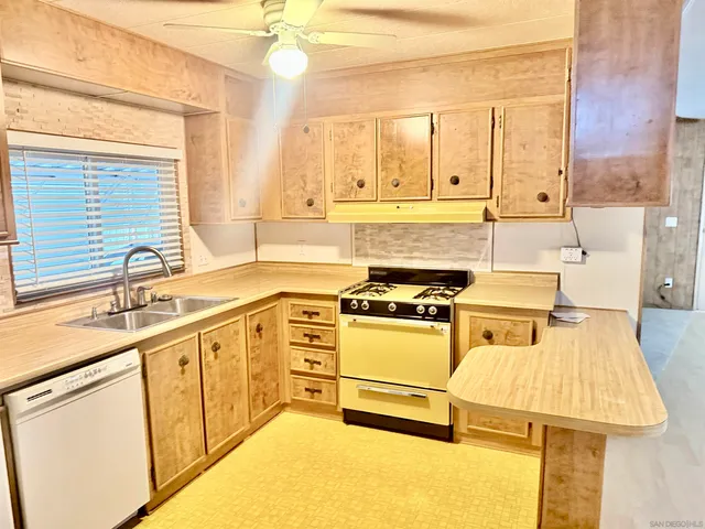 a kitchen with a sink stove and white cabinets
