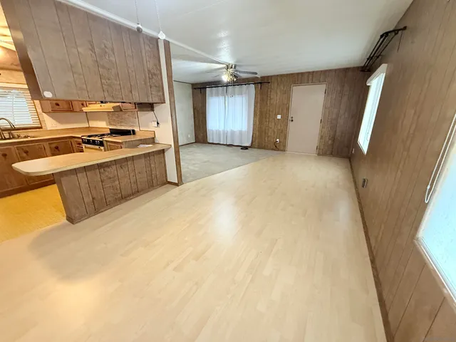 a kitchen with a sink a counter top space and cabinets