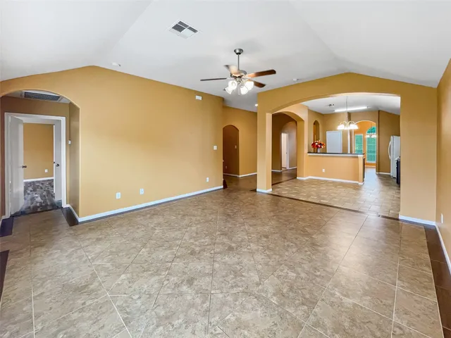 an empty room with fan and entrance