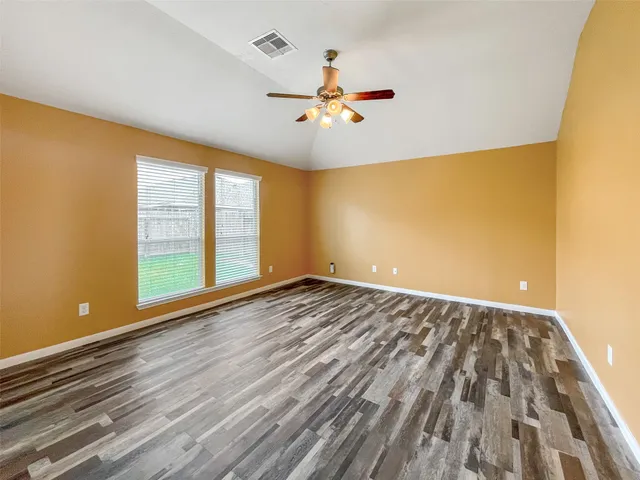 wooden floor in an empty room with a window