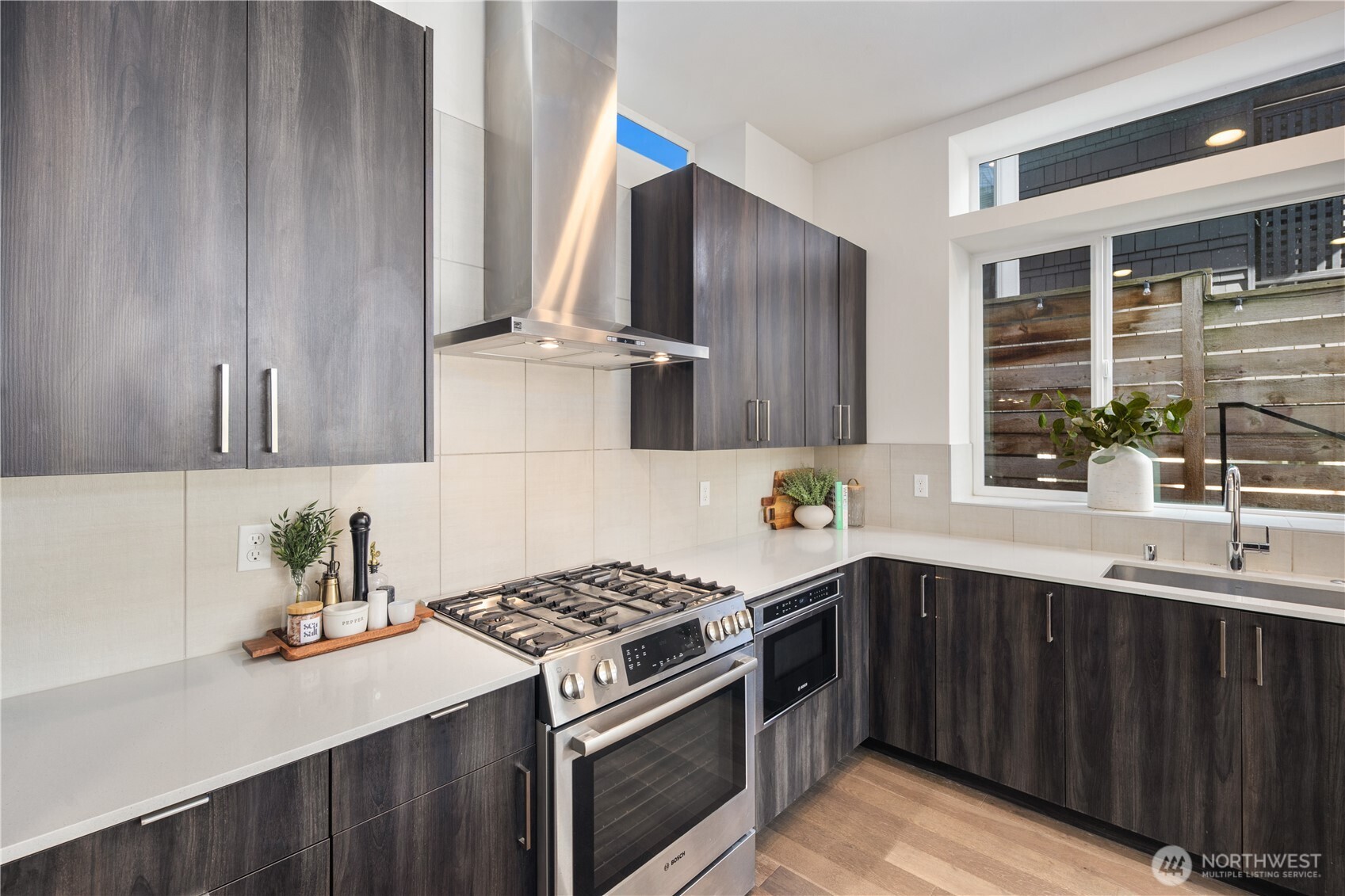 926 North 35th Street Seattle, WA 98103 - Photo 15 of 40 a kitchen with stainless steel appliances a sink a stove and a refrigerator