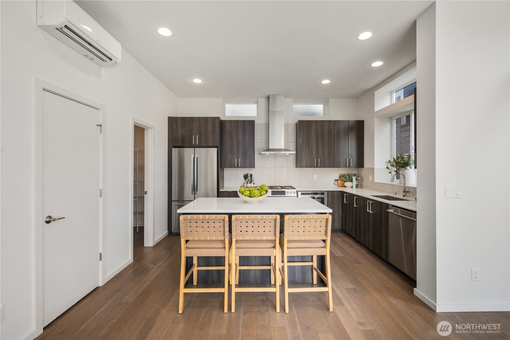 926 North 35th Street Seattle, WA 98103 - Photo 9 of 40 a kitchen with kitchen island wooden cabinets and stainless steel appliances