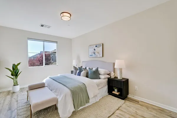 a bedroom with a bed and a window