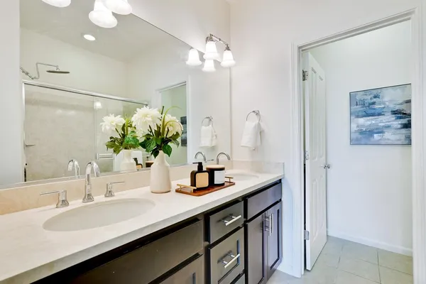 a bathroom with a sink double vanity and a mirror