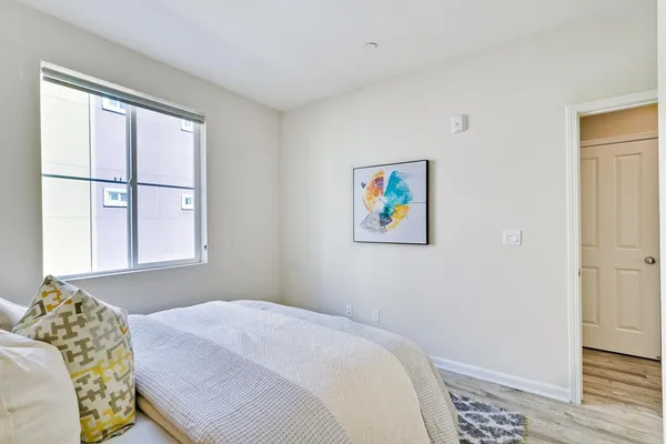 a bedroom with a bed and a window