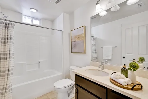 a bathroom with a sink double vanity granite toilet tub and shower