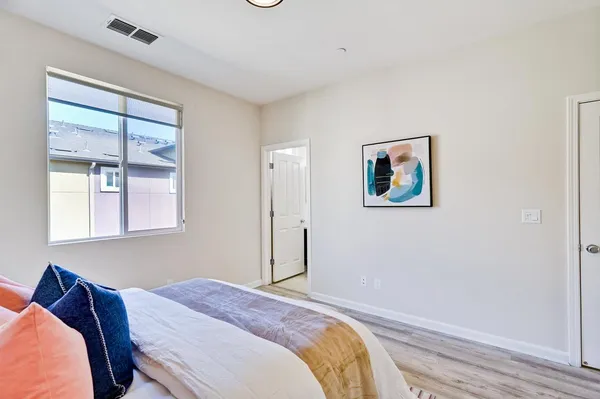 a bedroom with a bed and a window