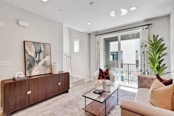 a living room with furniture potted plant and a window