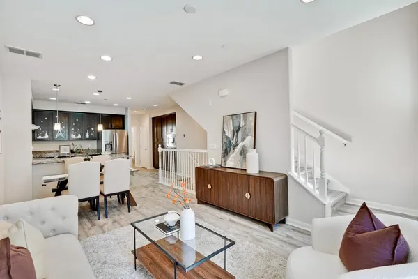 a living room with furniture and a wooden floor