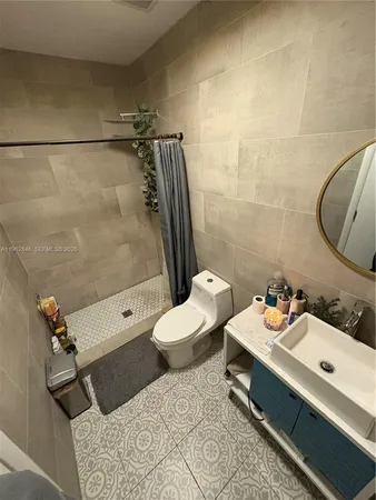 a bathroom with a sink mirror vanity and toilet