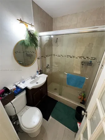 a bathroom with a sink toilet and shower