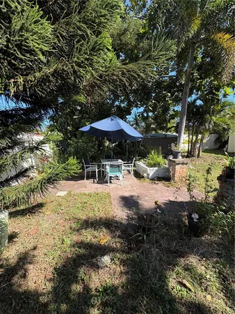 a view of patio with chairs and wooden fence