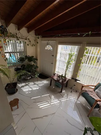a view of a porch with furniture and a potted plant